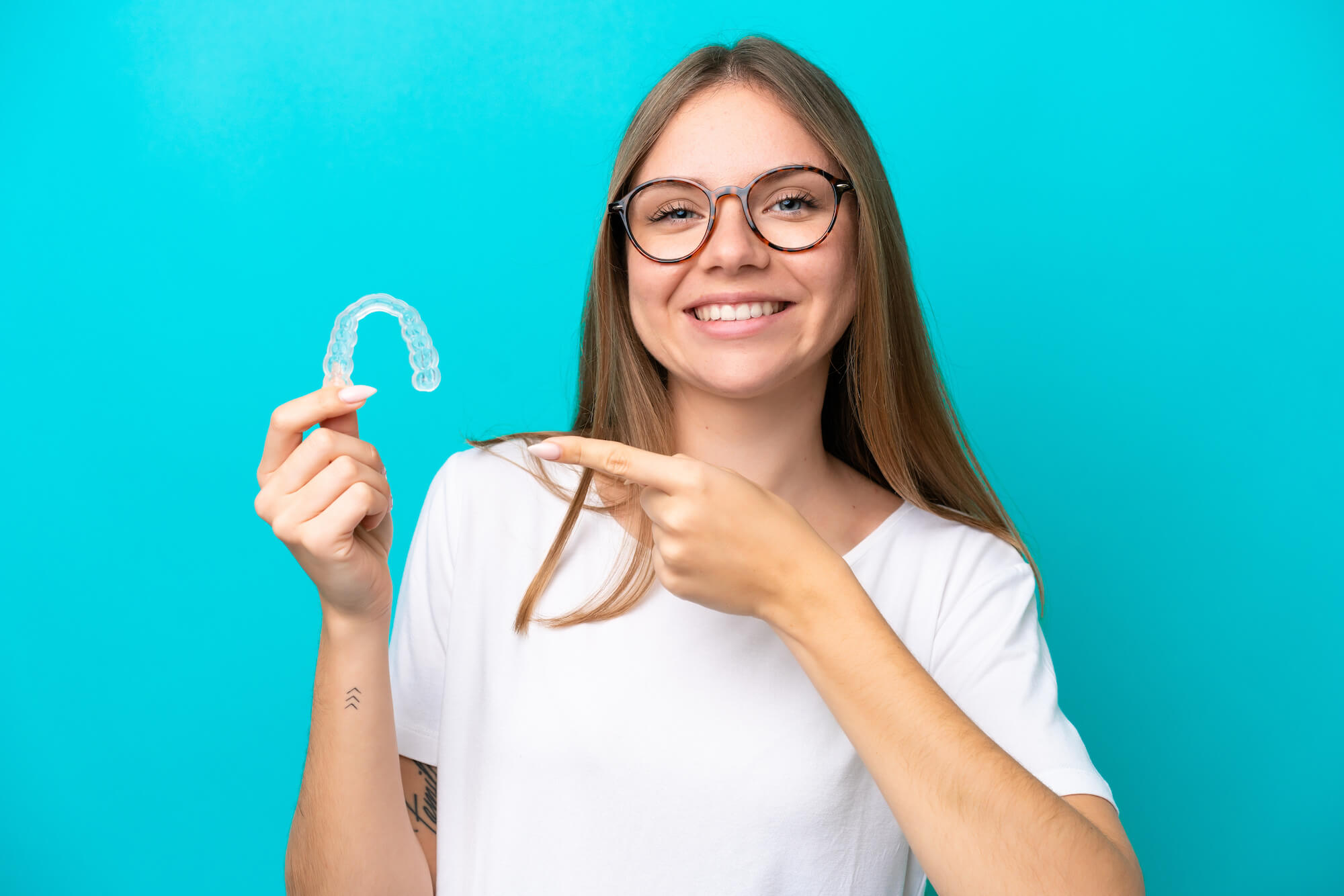 Woman holding Invisible Braces